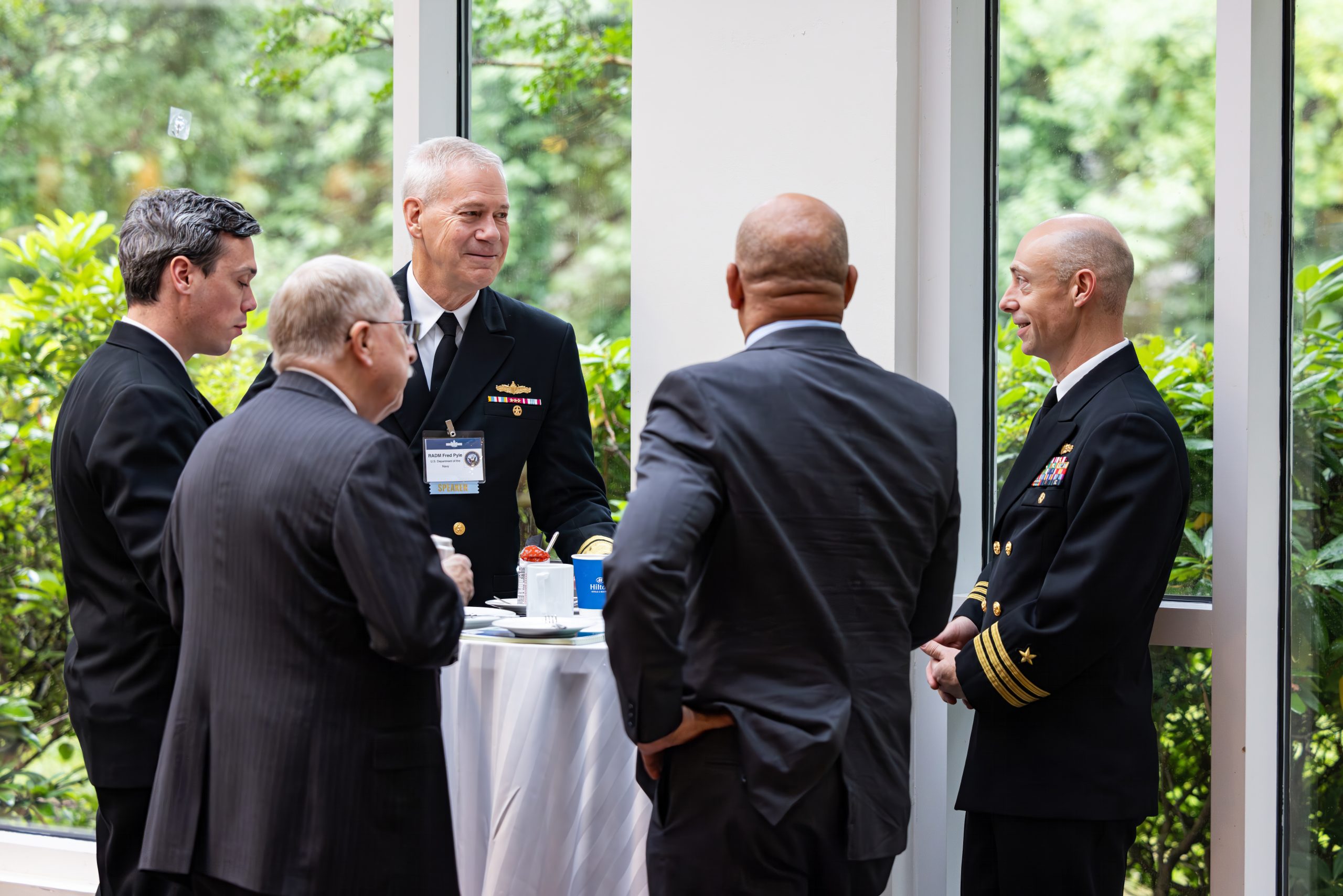 U.S. Navy officials engage with attendees at a Potomac Officers Club event.